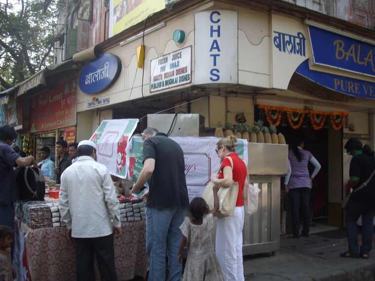Customers buying from a sweet shop counter on Hill Road, Bandra, Mumbai